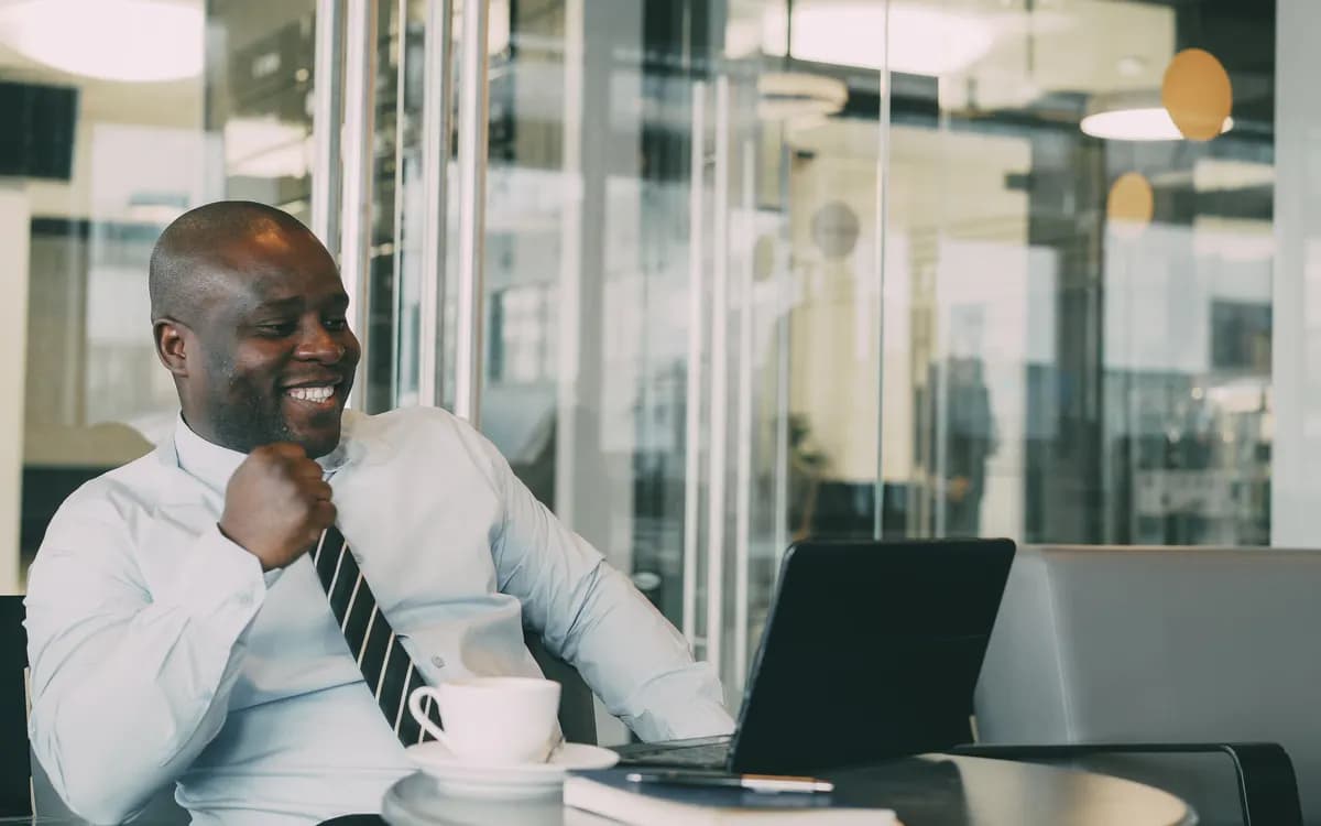 A manager reviewing his team’s progress on a laptop